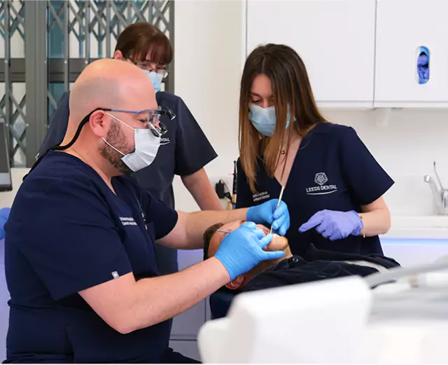 A team of dental professionals performing a surgical tooth extraction at Leeds Dental Clinic, ensuring a safe and comfortable procedure for the patient.