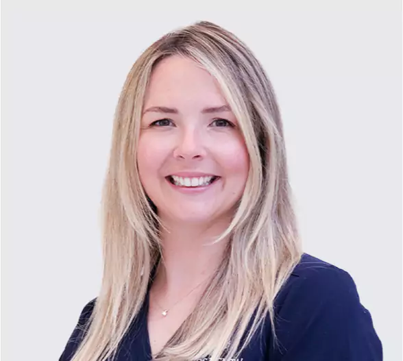 Smiling female dental professional at Leeds Dental Clinic.