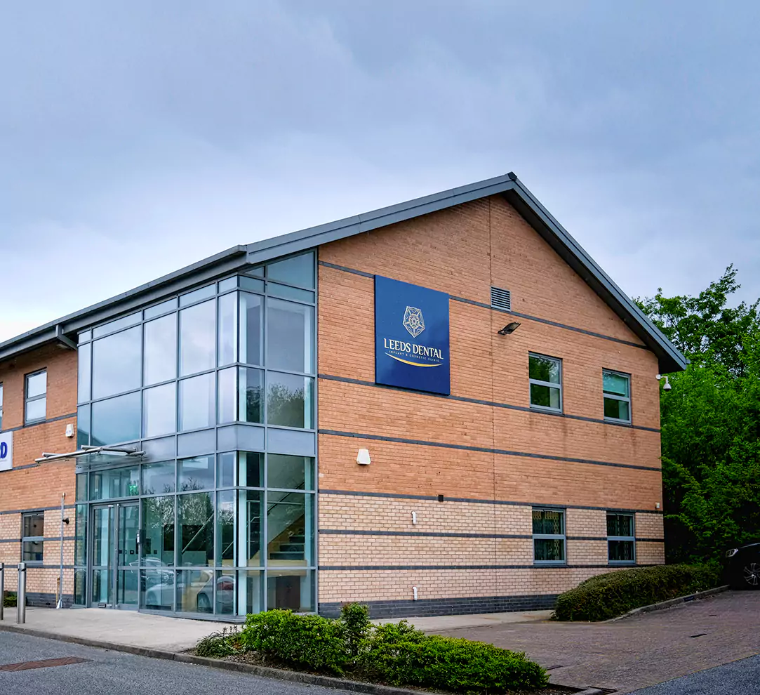 Exterior view of Leeds Dental Clinic, a modern brick and glass building.