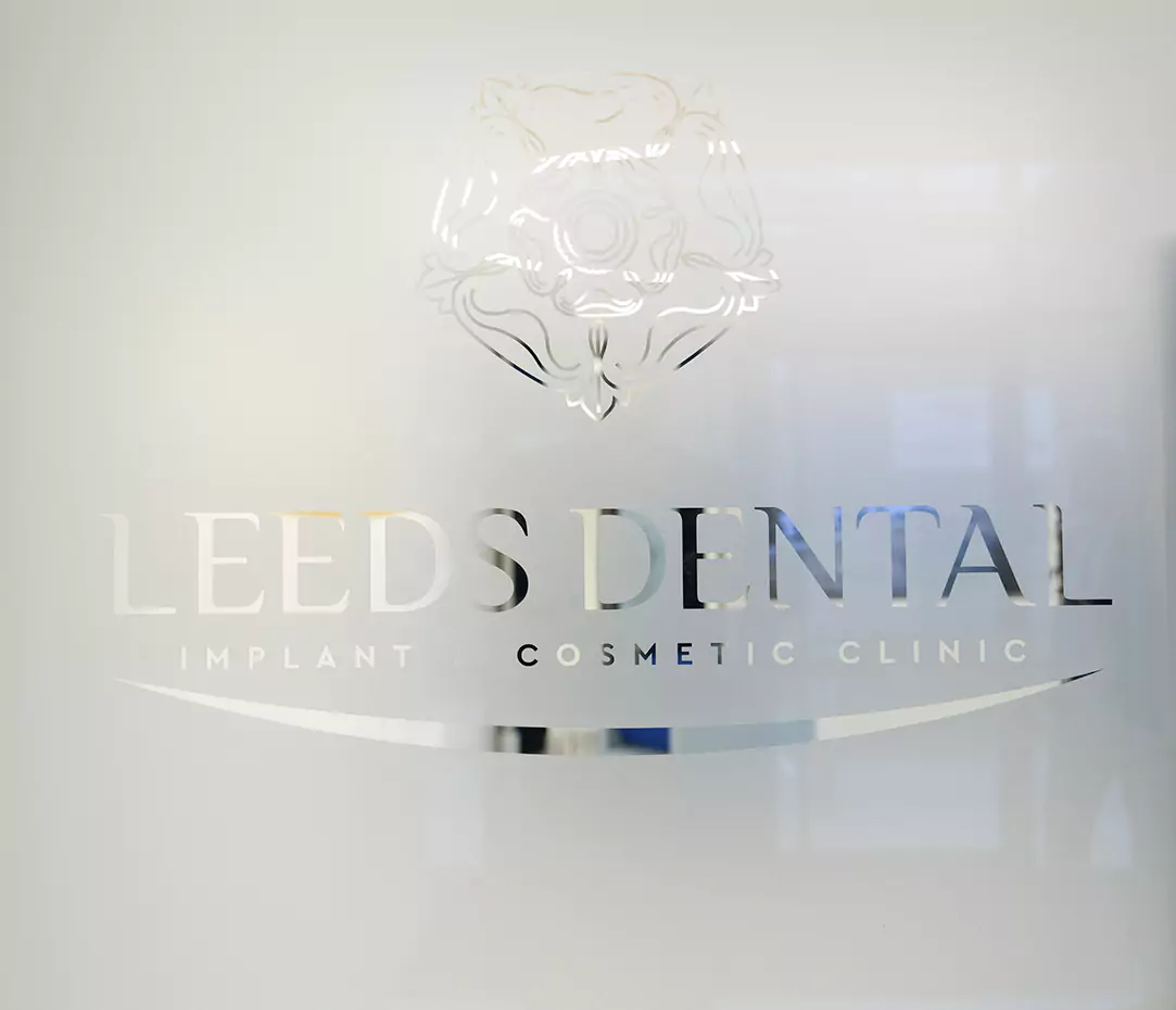 Frosted glass logo of Leeds Dental Implant & Cosmetic Clinic.
